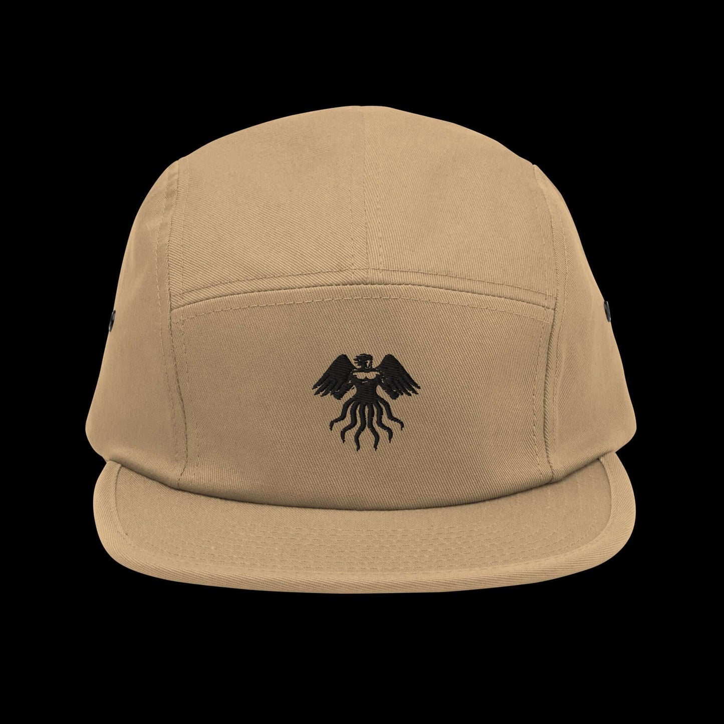 Five panel cap in tan with black logo, soft-structured, low profile, and nylon strap clip closure for comfort and style.